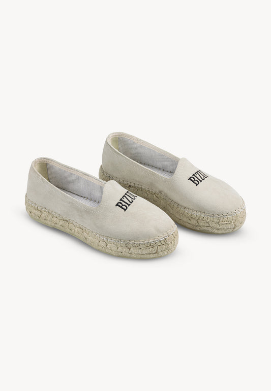 Creamy AYLA espadrilles at a 45° angle on a gray background.