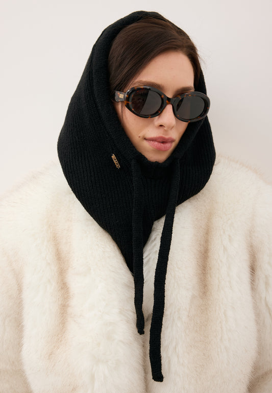 Close-up of the model wearing the black BALA balaclava and ENNA sunglasses.