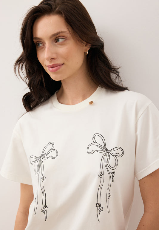 Close-up of the model wearing the BOW T-shirt with bow illustration.