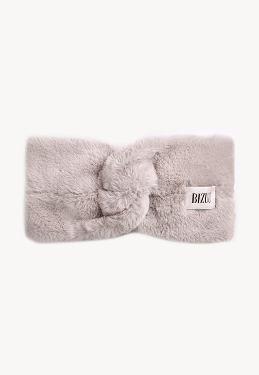 Beige faux fur FEMI headband with a decorative twist and jacquard label.