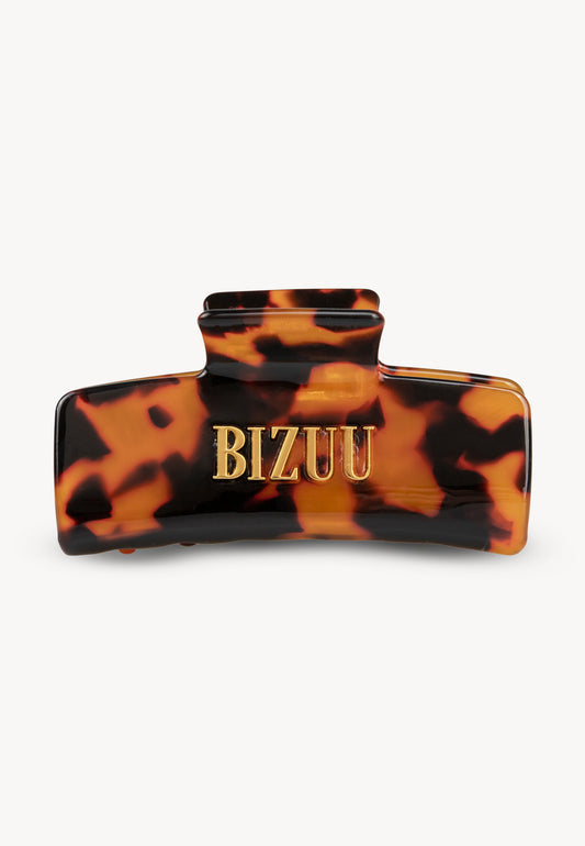 Tortoiseshell GLIMMA hair clip with BIZUU logo.