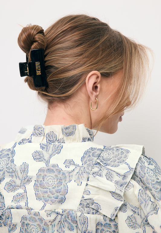 Black GLIMMA hair clip with logo