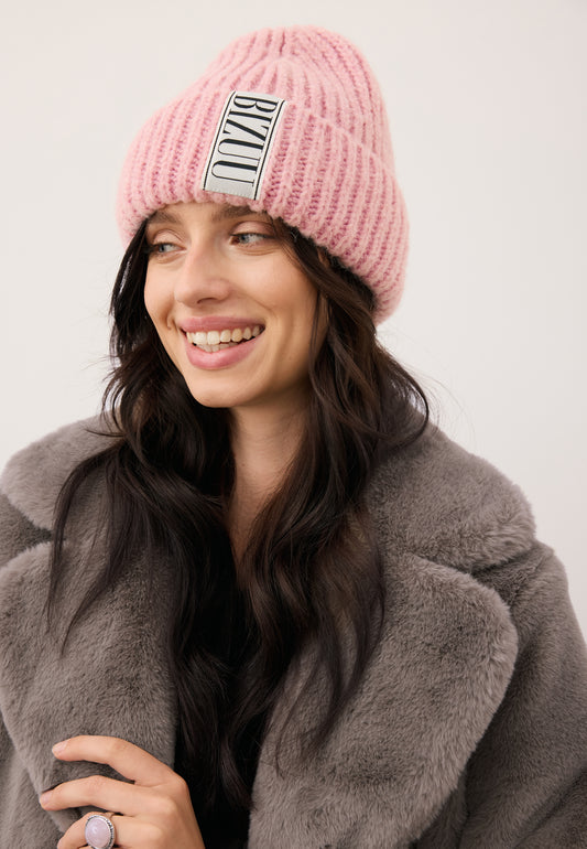Smiling model wearing a pink LORRO cap with a logoed label on the front.