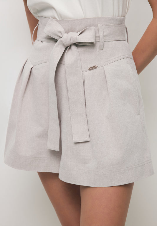 Close-up of the KANDYS beige high-waisted shorts.