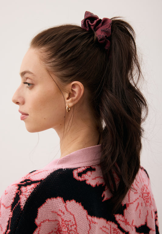 Close-up of the model’s hair styled in a ponytail with the burgundy SILKY silk scrunchie.