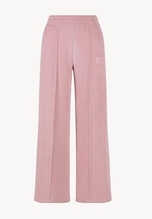 The front of pink VELORINA sweatpants displayed on a white wall.