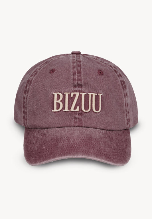 Front view of the burgundy ZANE cap with embroidered logo.