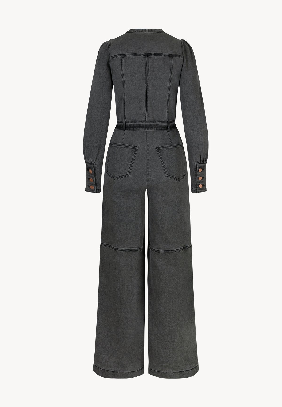 Rear view of a dark gray denim jumpsuit with long sleeves, wide legs, back pockets, and belt loops. Sleeves finished with cuffs with three buttons.