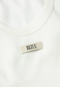 Cream ribbed top with EJRIS logo
