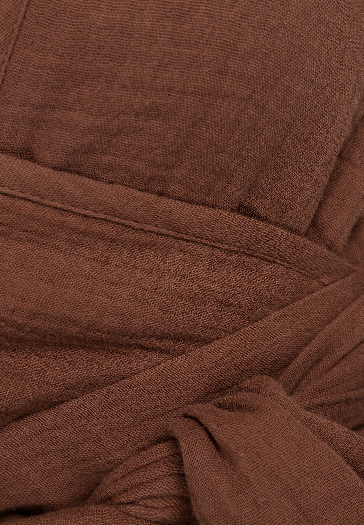Close-up of the binding of TARI's brown muslin strapless top