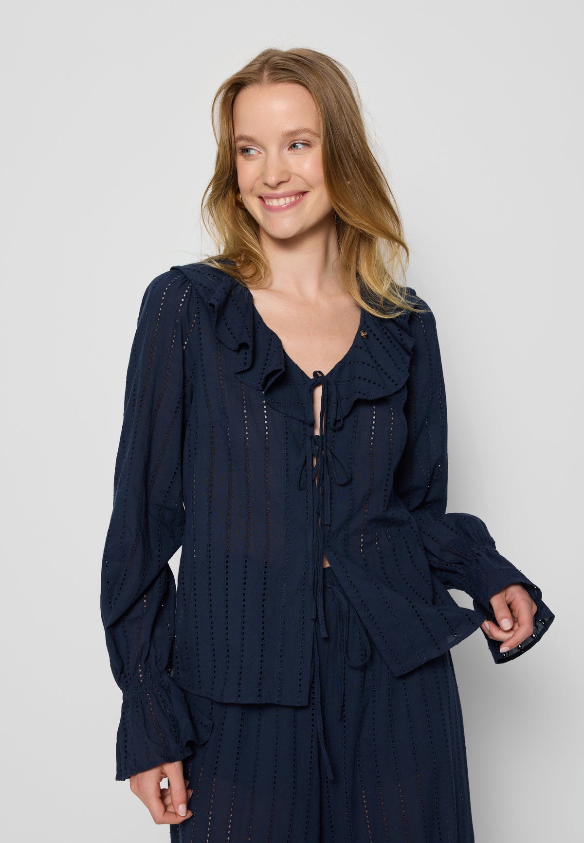 Smiling model in navy blue PROVANCE blouse.