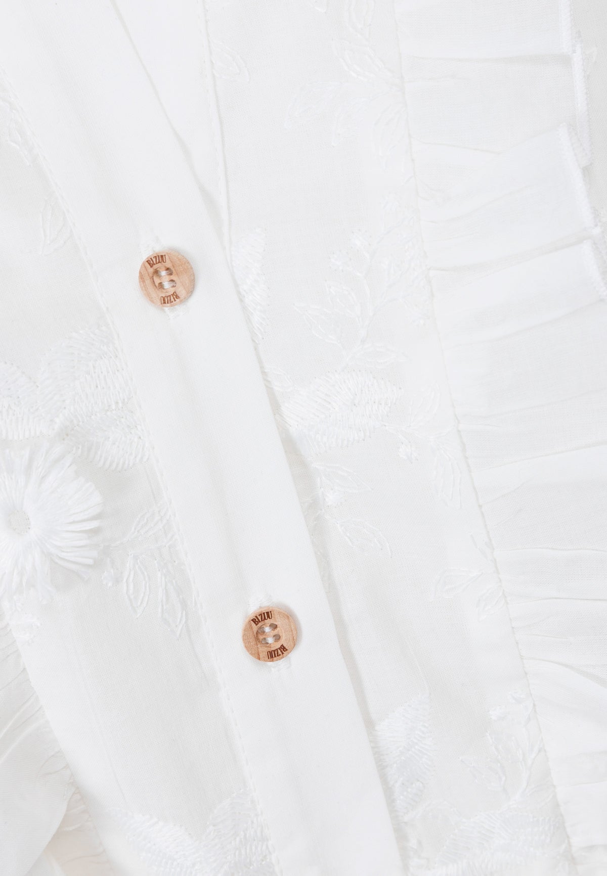 A close-up of the wooden buttons on the front of the NATTA dress.