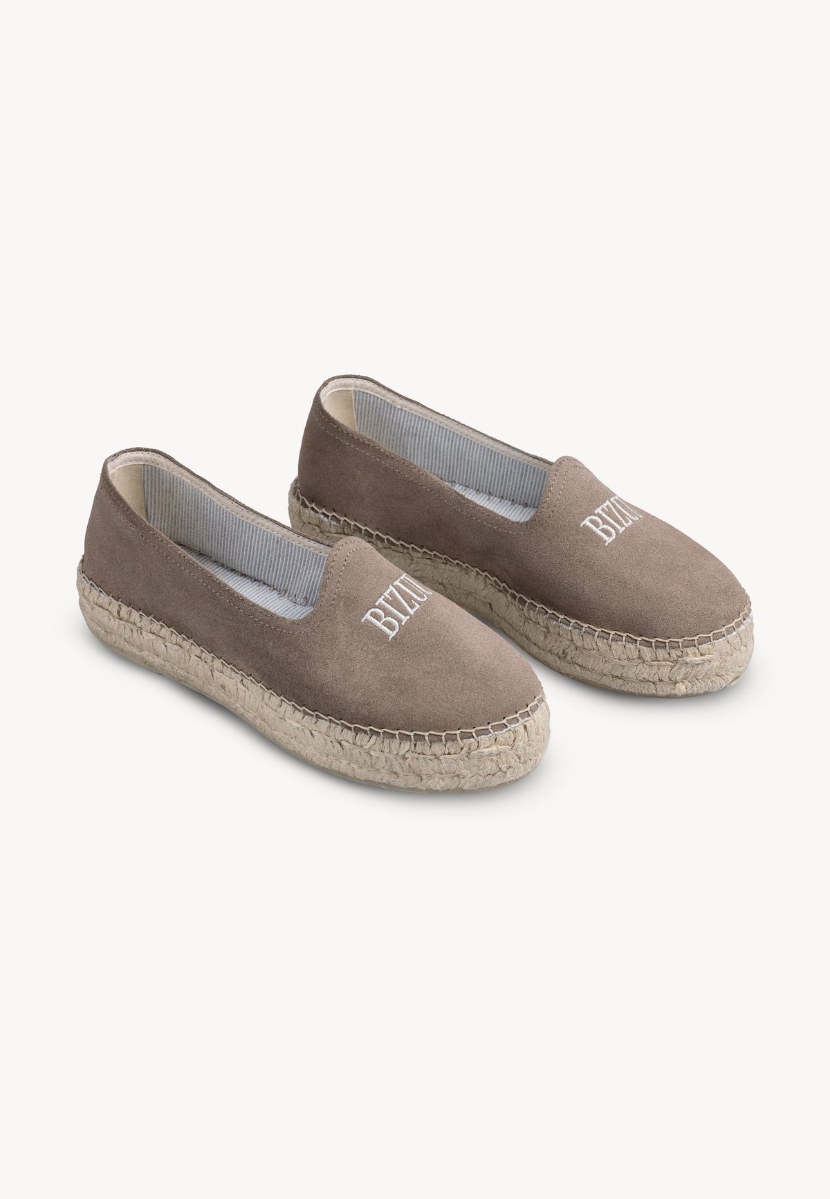 Espadrilles in taupe color AYLA on the leg, side view.