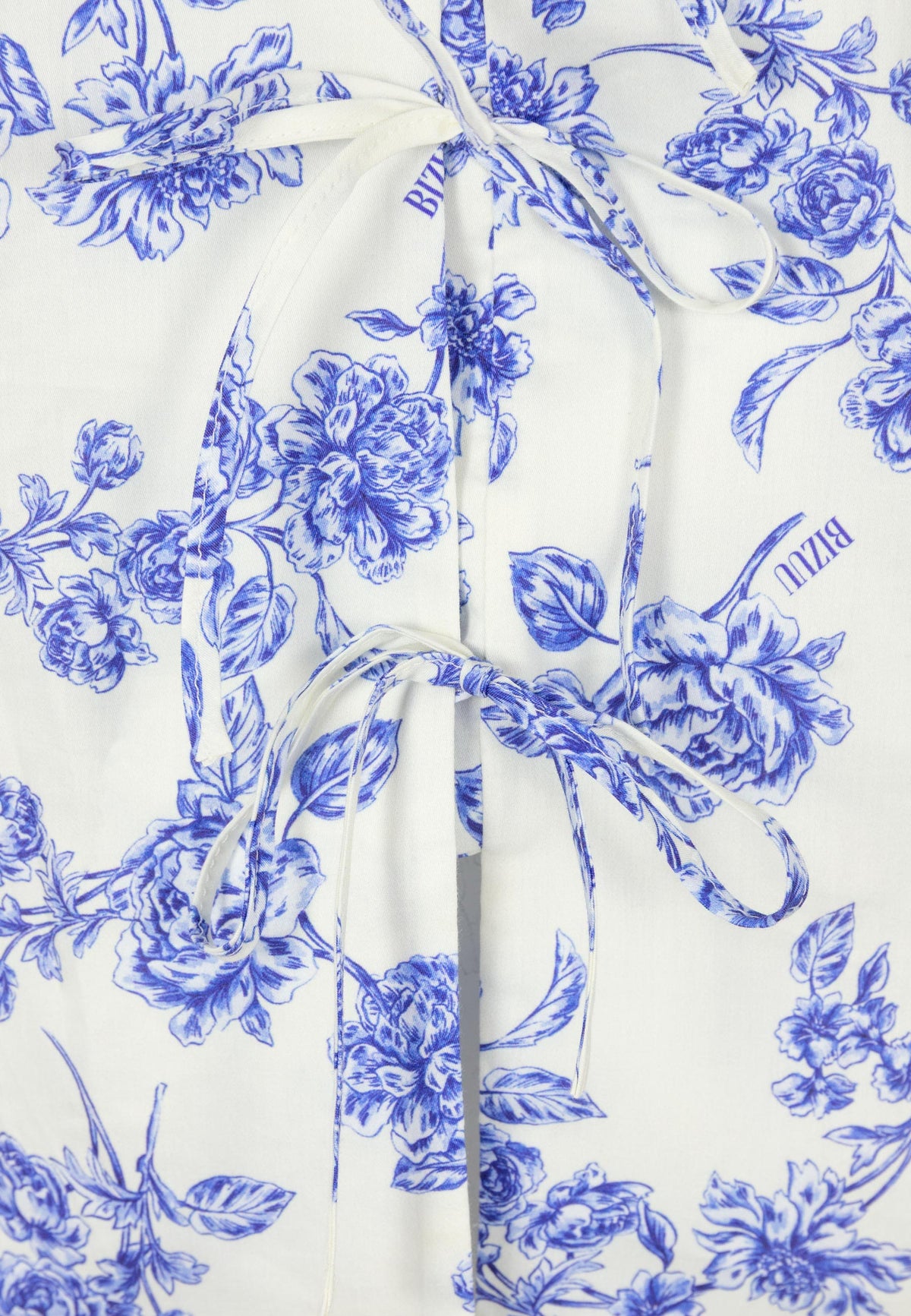 Close-up of the blue floral print used in the ALIANNA cotton blouse.