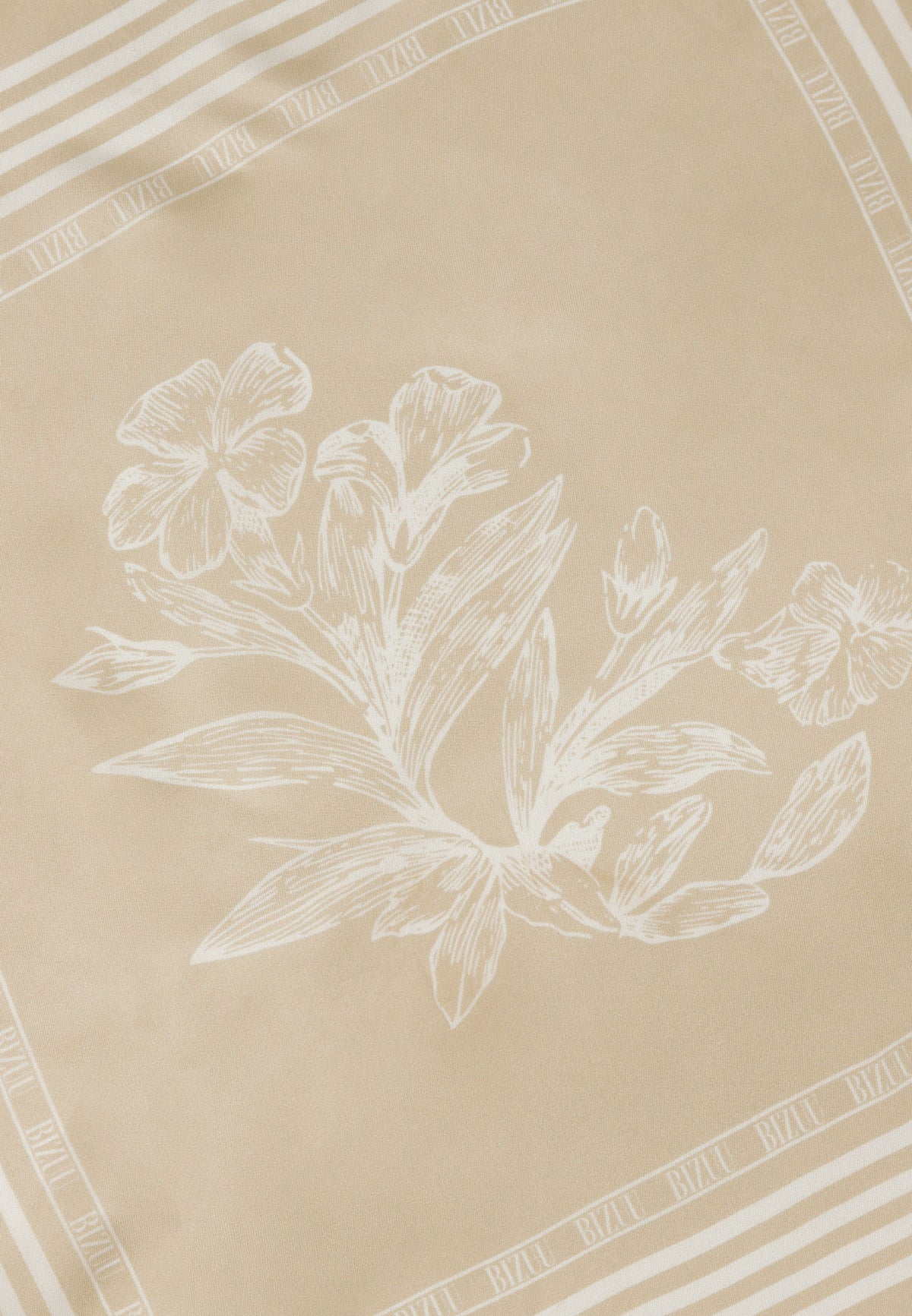 Floral pattern detail at the center of the beige ARIA silk scarf.