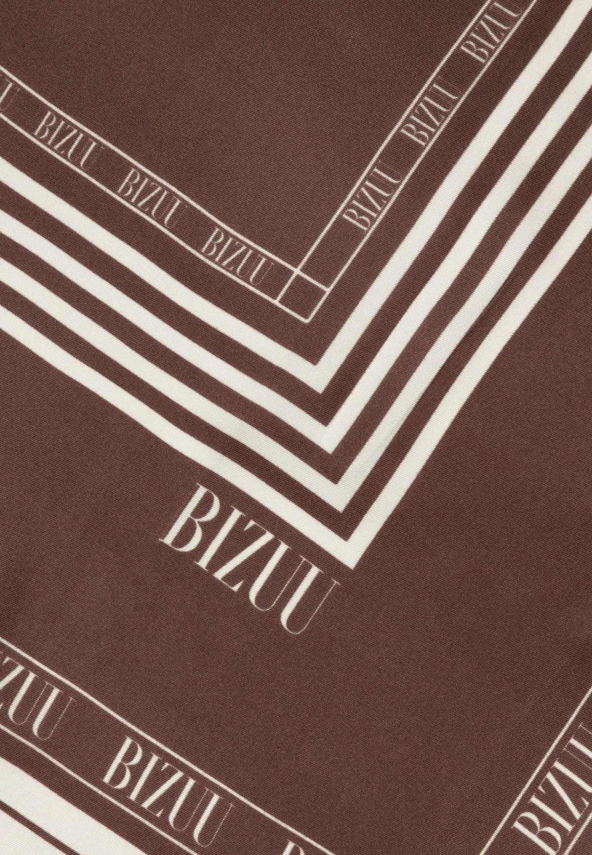 Close-up of the logo on the brown ARIA silk scarf.