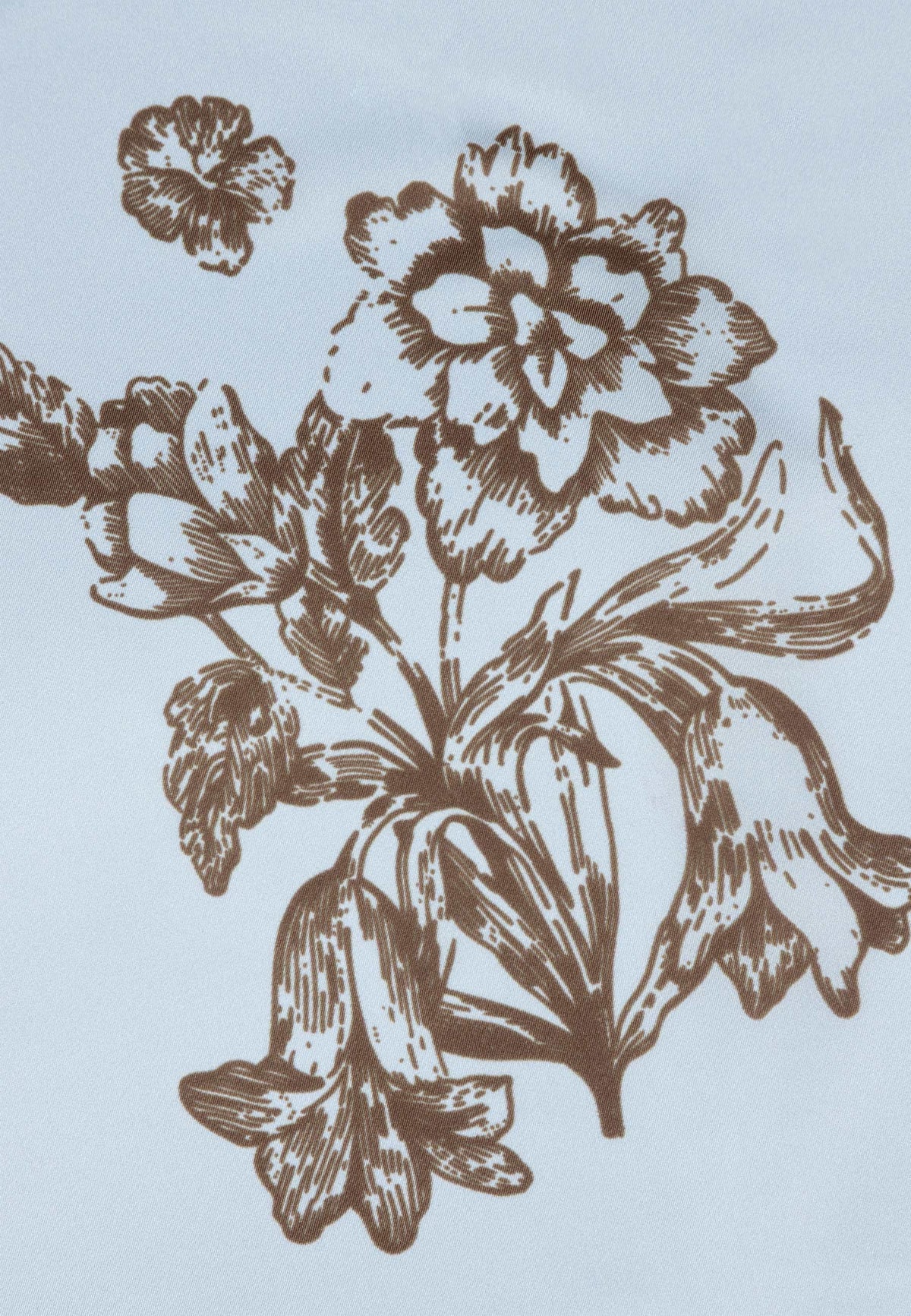 Brown floral pattern detail on the ARIA silk scarf in blue.