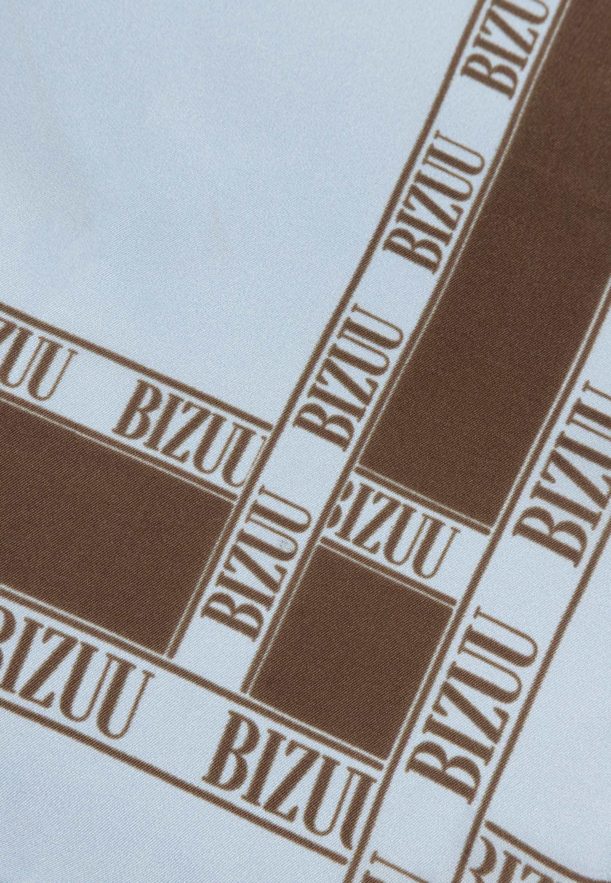 Close-up of the brown logo on the blue ARIA silk scarf.