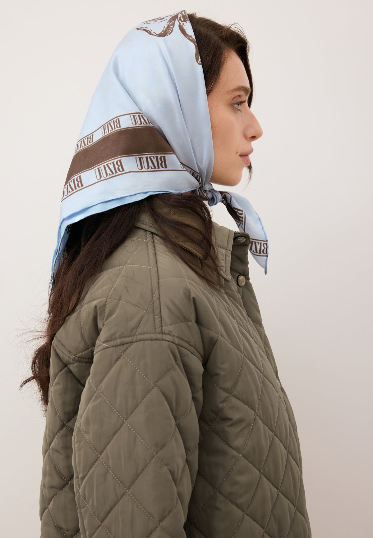 Model wearing the blue ARIA silk scarf tied around her head.