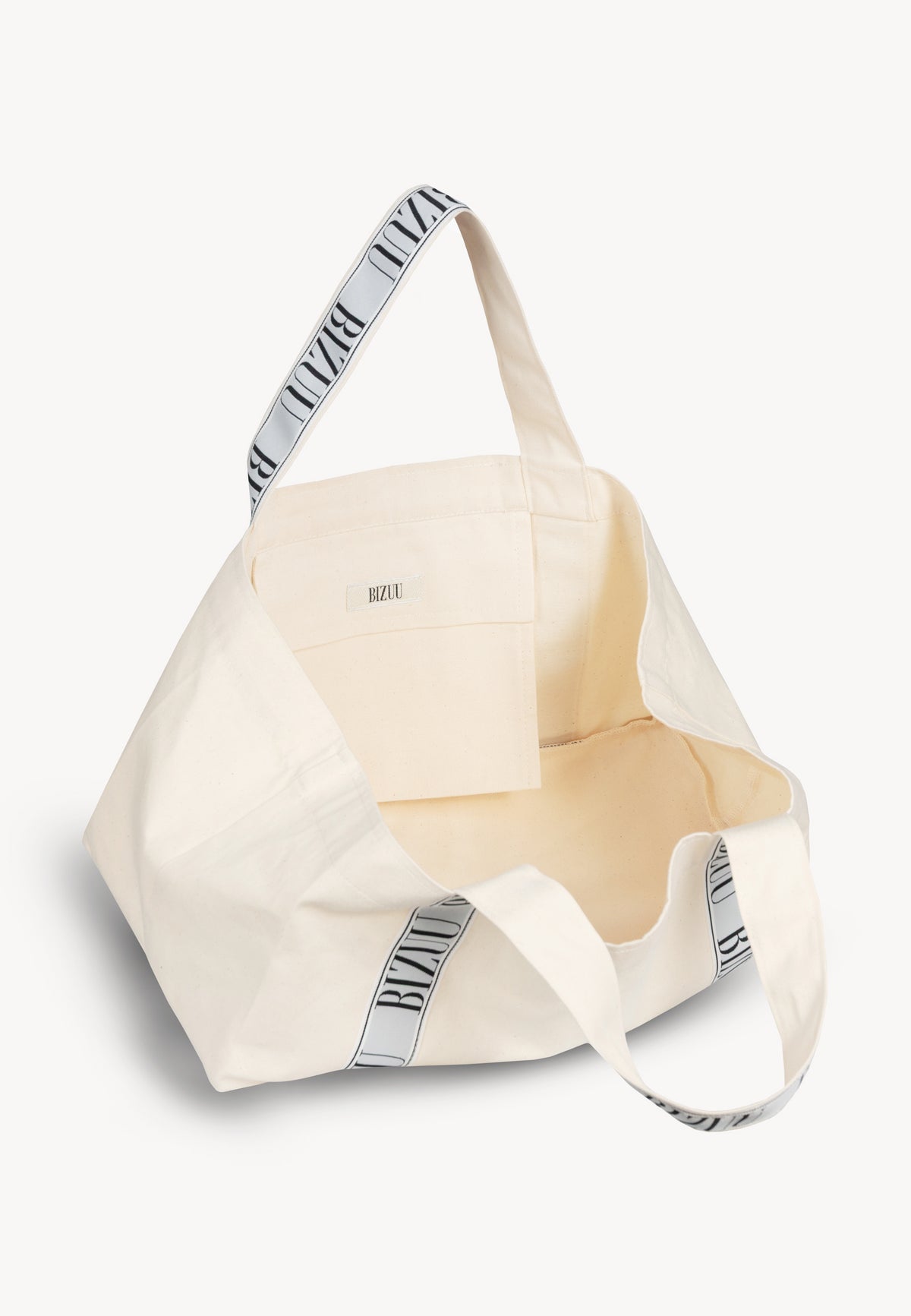 The center of a beige BAGO mini bag with logoed straps shown at an angle.