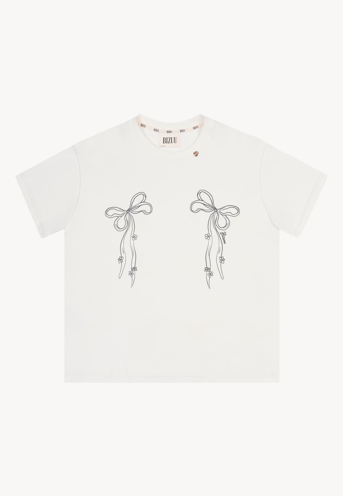 Front view of the cream BOW T-shirt featuring bow illustrations and a gold medallion at the neckline.