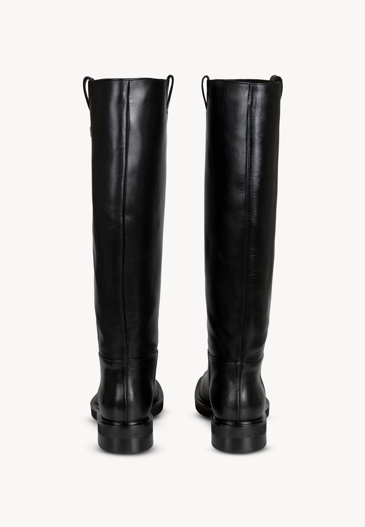 Close-up of the shaft of the CALYX leather boots with gold logo detail.