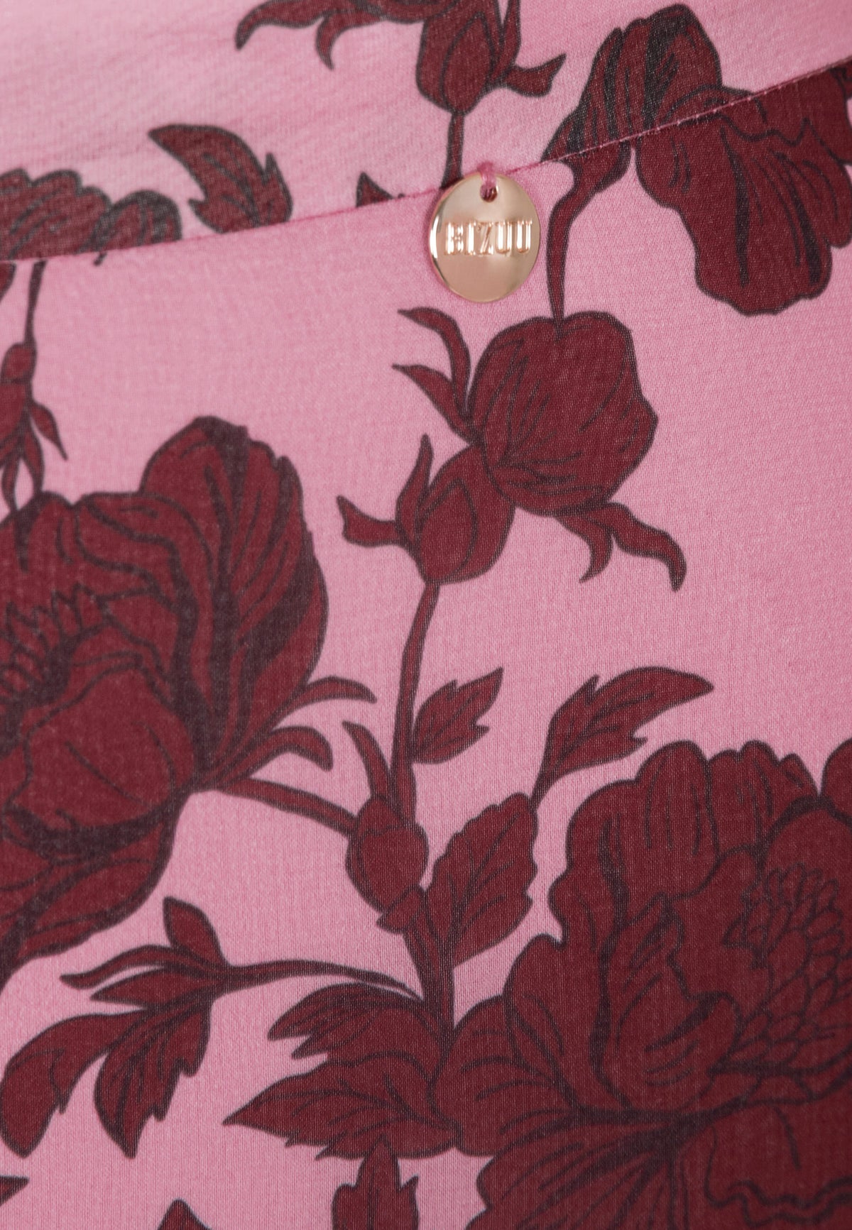 Close-up of the medallion with the logo on the CANDICE skirt.