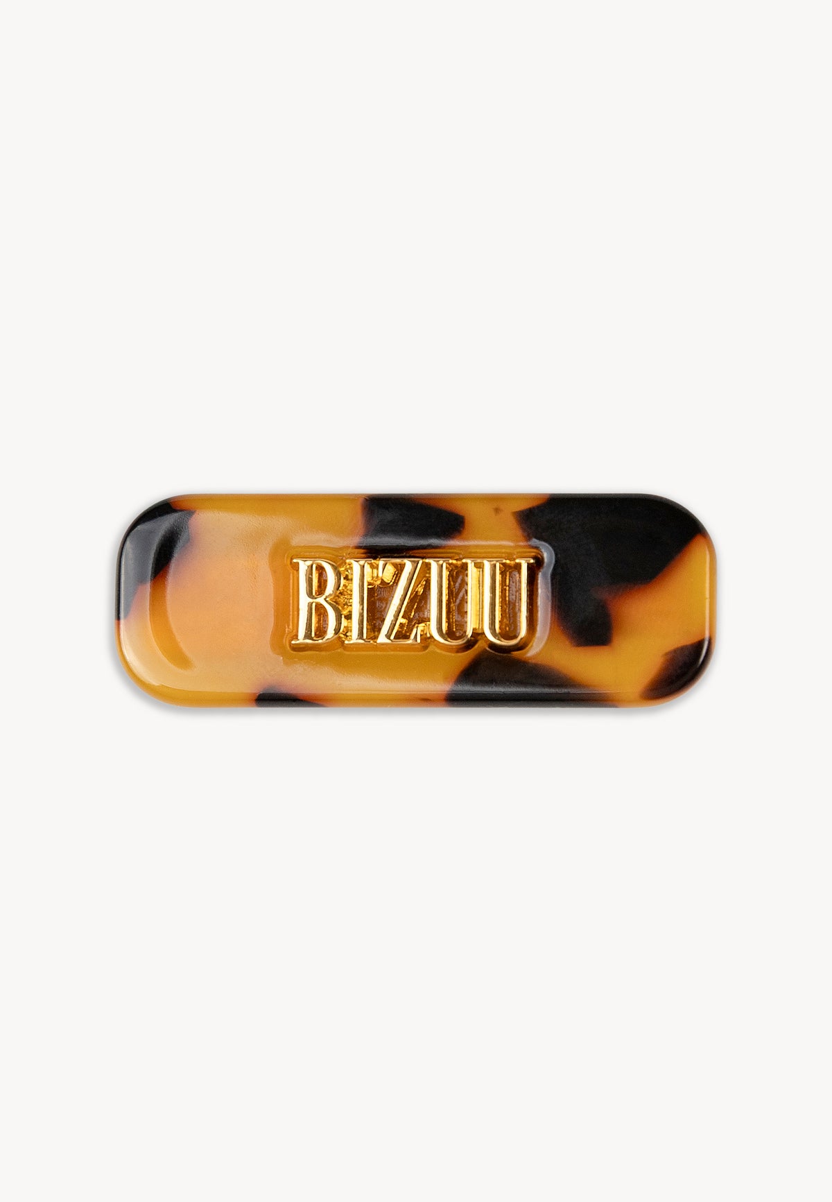 Small tortoiseshell CATTA hair clip with gold logo.