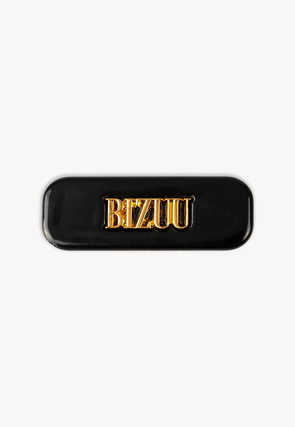 Small black CATTA hair clip with central logo.