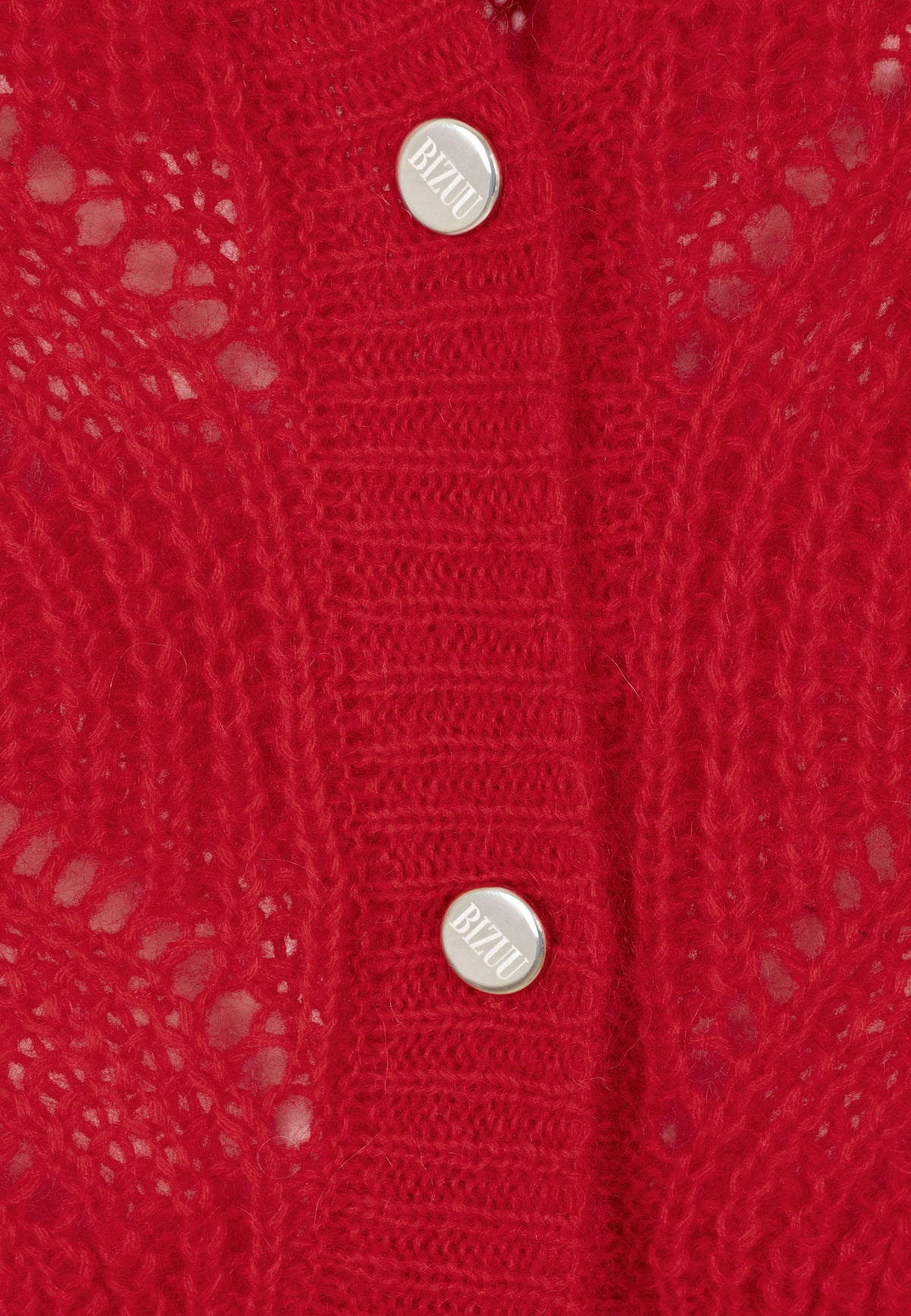 Close-up of the golden branded buttons on the CLARA sweater.