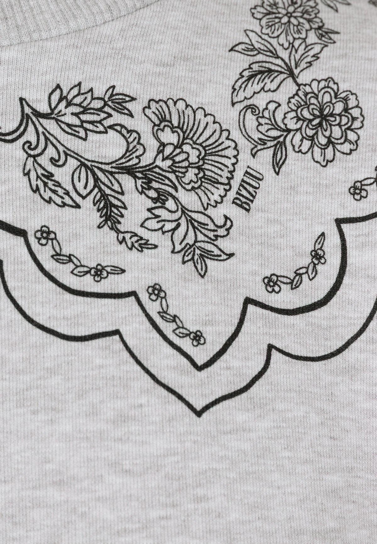 Close-up of the illustrated collar on the COLLIER sweatshirt.