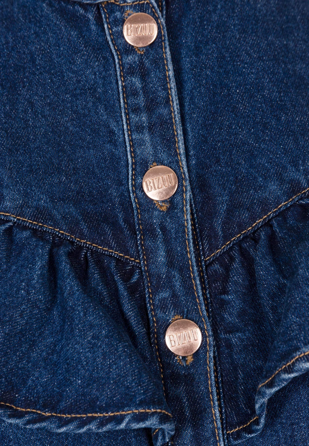 Close-up of the branded buttons on the DILETTA denim shirt.