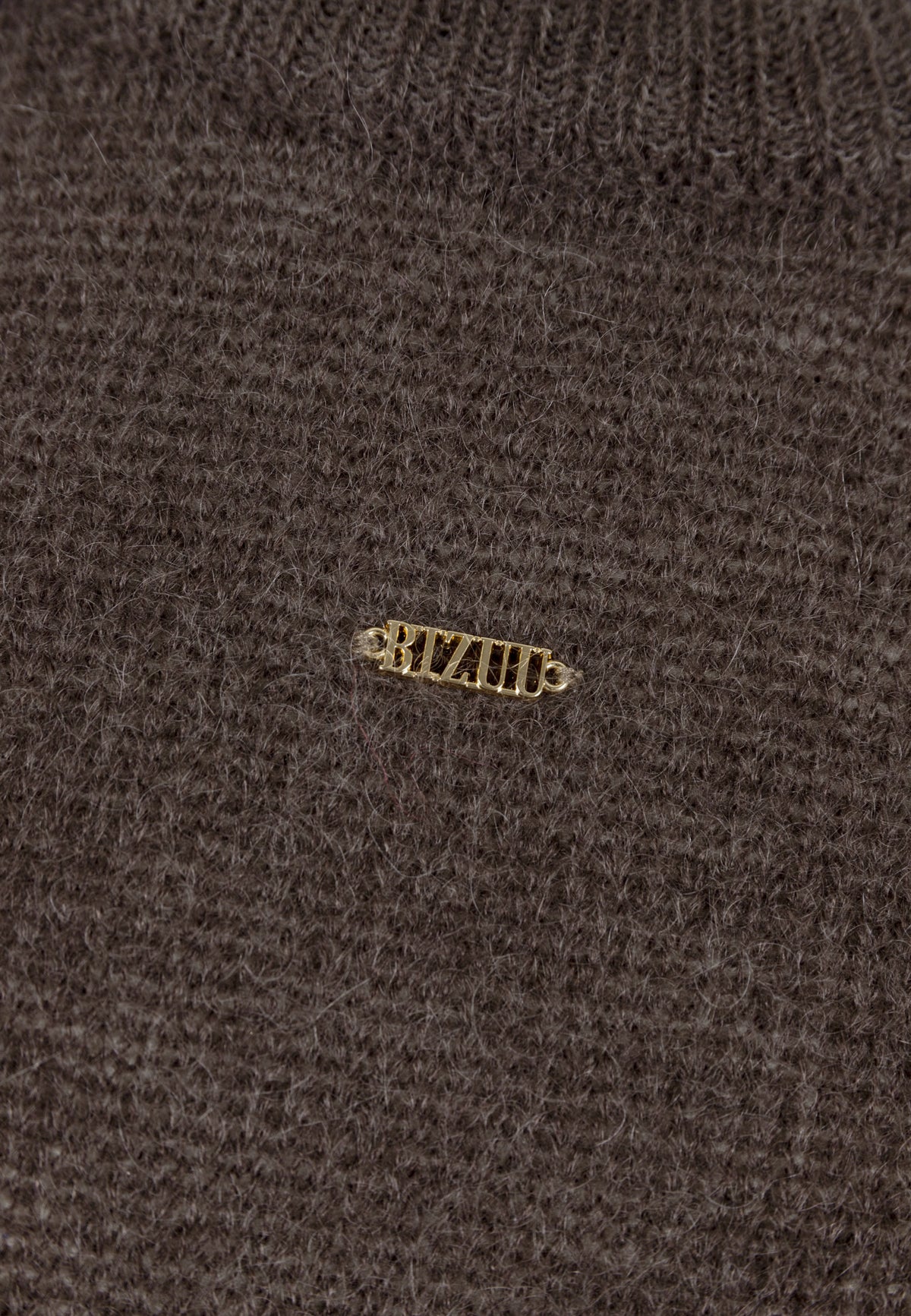 Close-up of the logo on the front of the brown FAROA sweater.