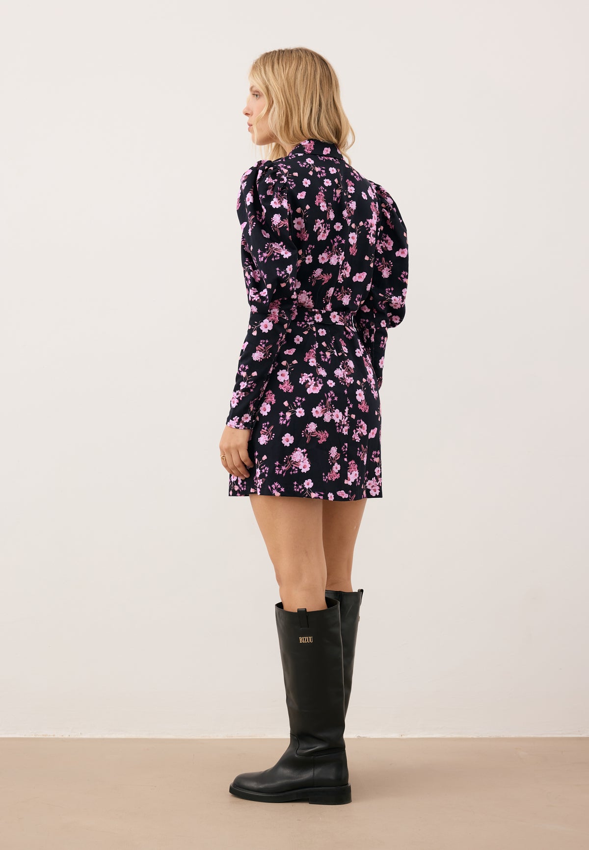 Model standing with her back to the camera, wearing the printed GEORGINA dress.