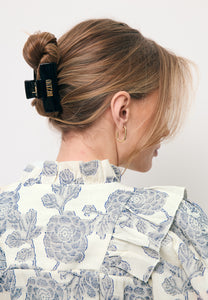 Black GLIMMA hair clip with logo