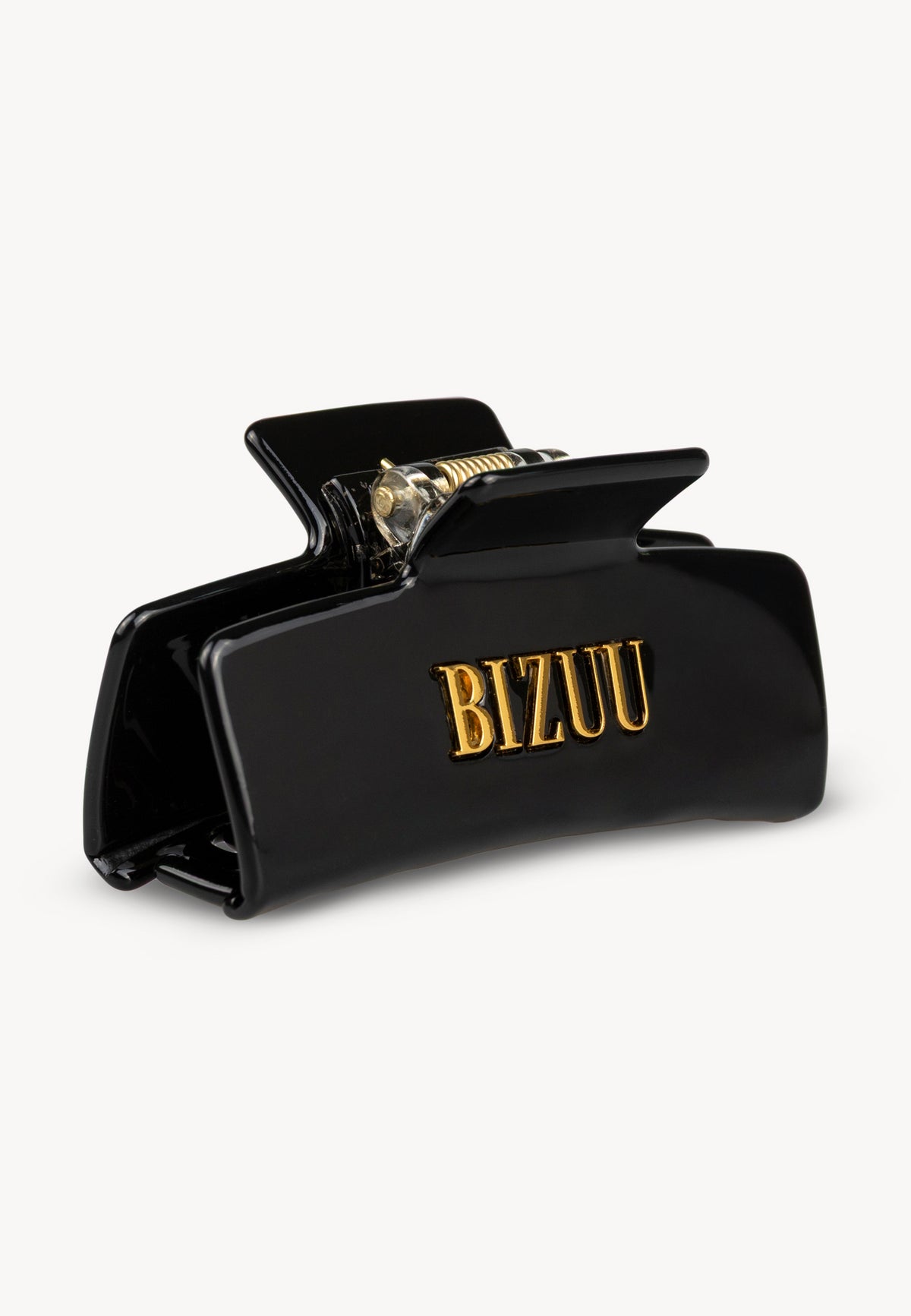 Black GLIMMA hair clip with gold logo.