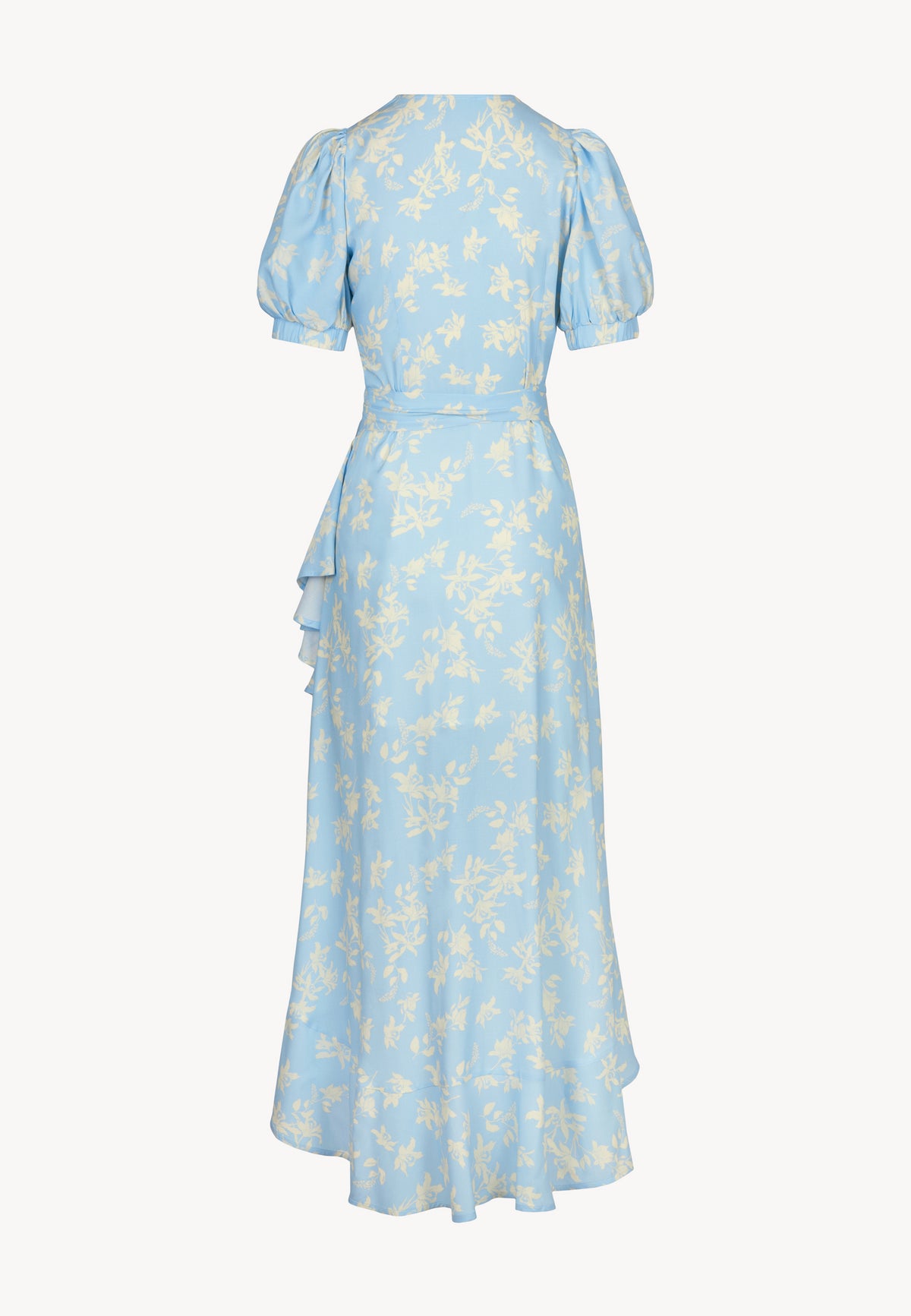 The back of the envelope dress in cream flowers on a blue background ISLAY, which is finished with a decorative ruffle.