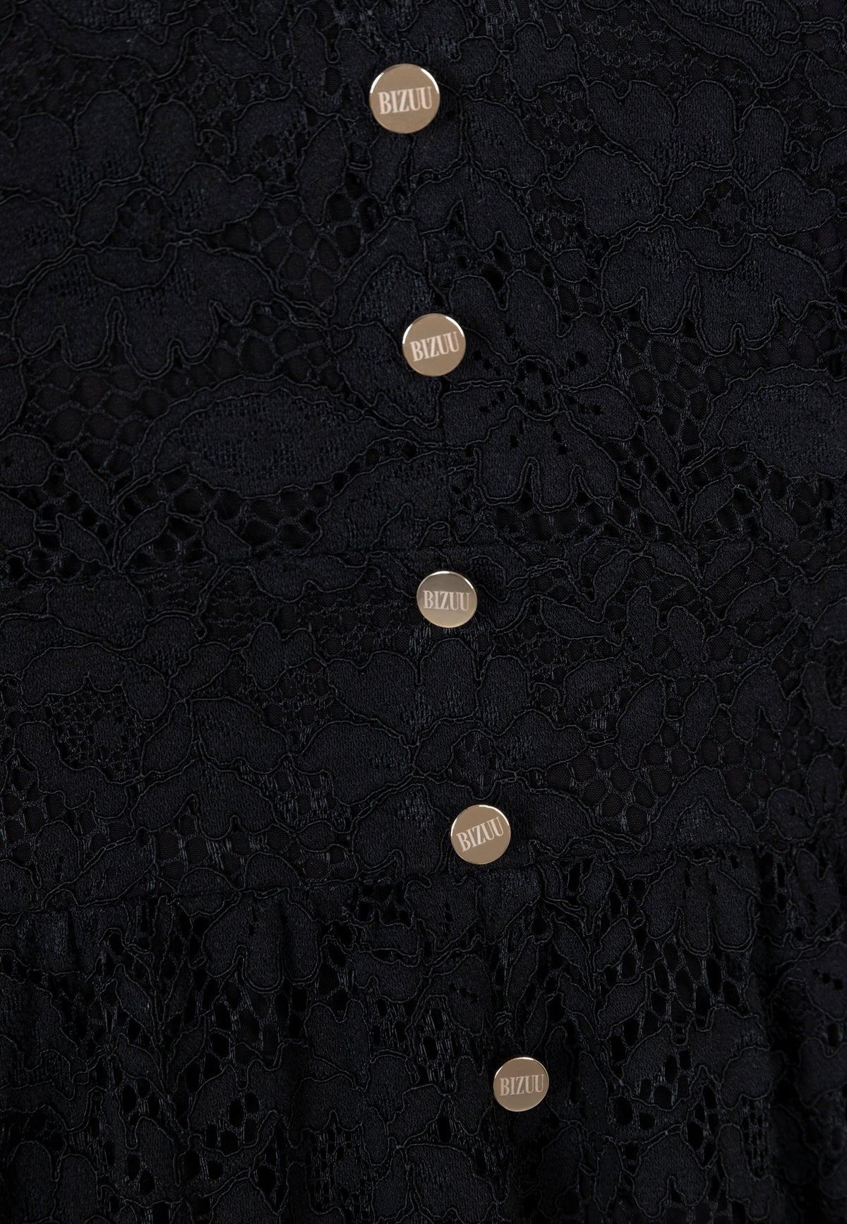 Close-up of the gold buttons on the front of the ISORELLA lace dress.
