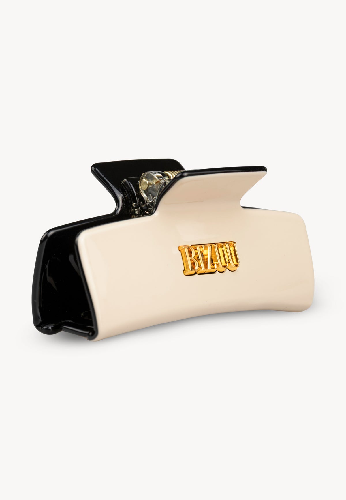 Cream IVORIA hair clip with black details and gold logo.