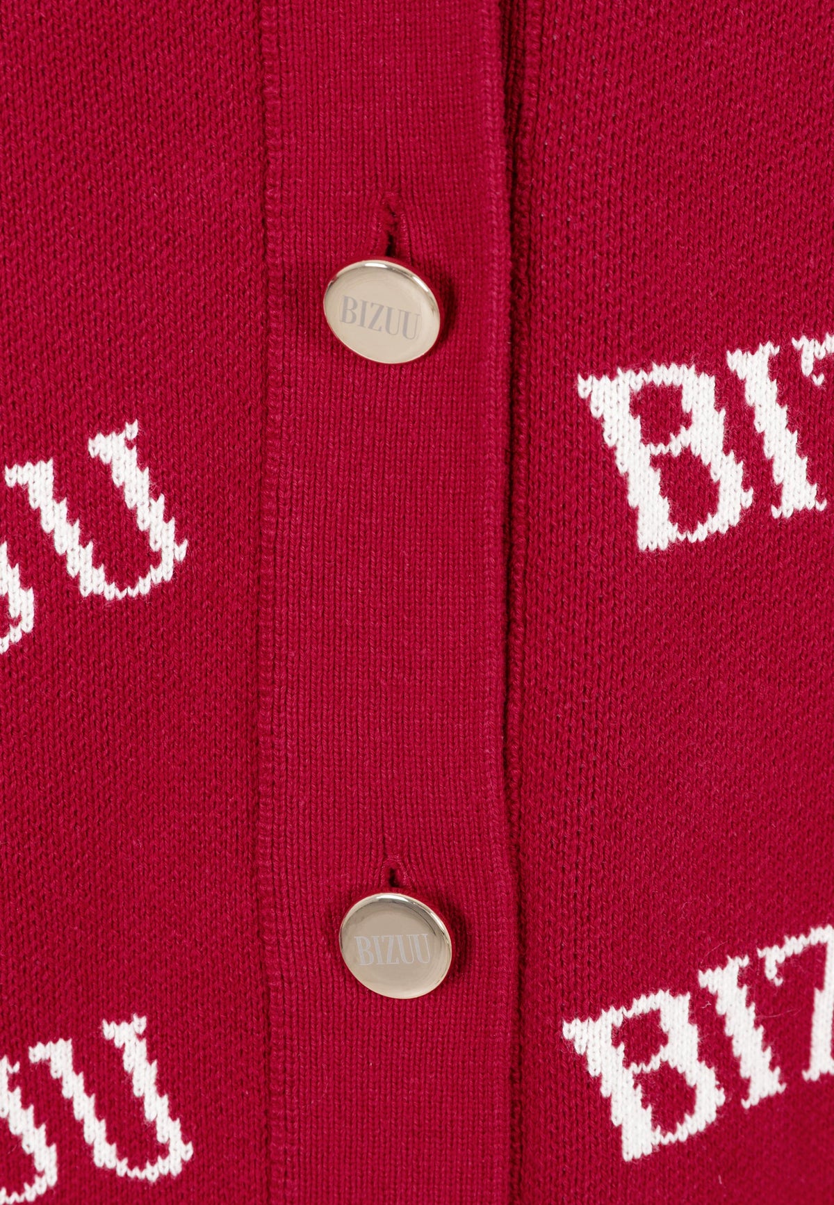Close-up of the golden buttons on the burgundy KYLE sweater.