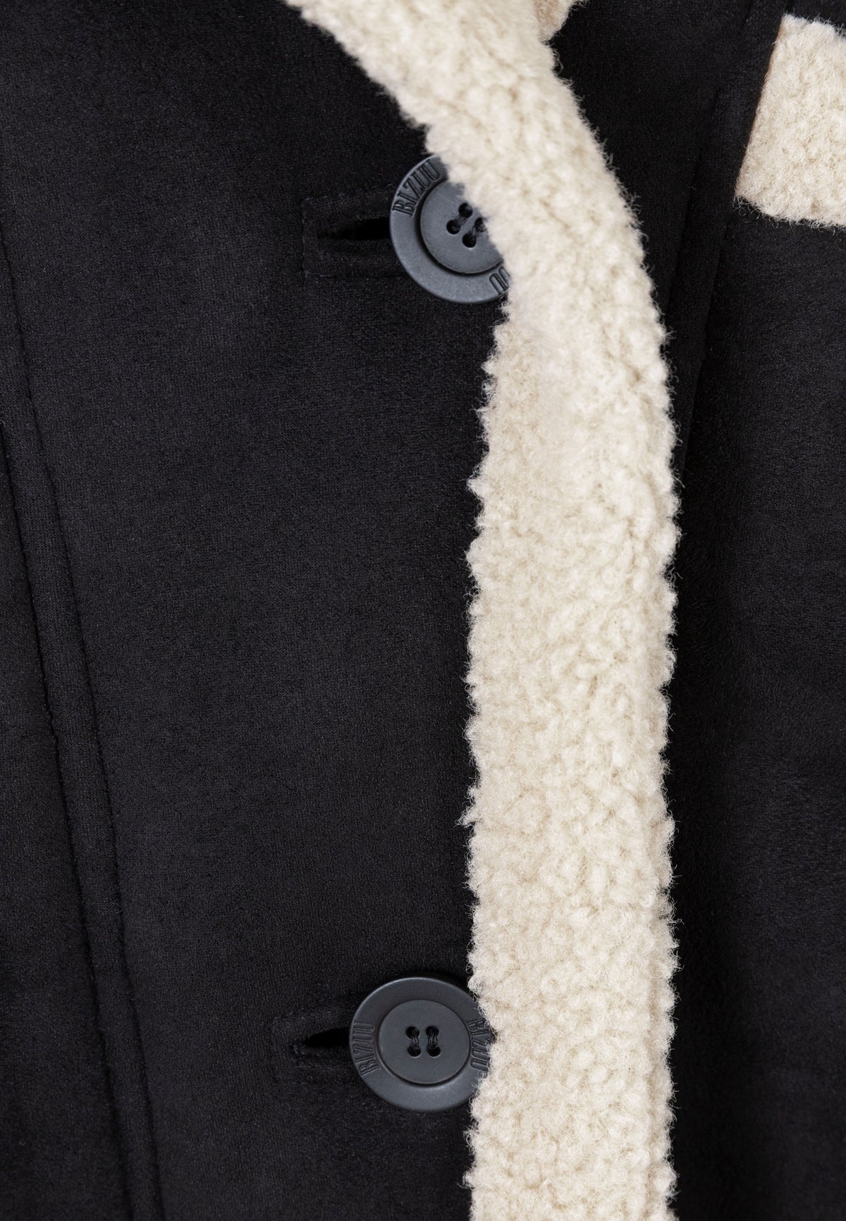 Close-up of the branded button on the LAFARA shearling jacket.