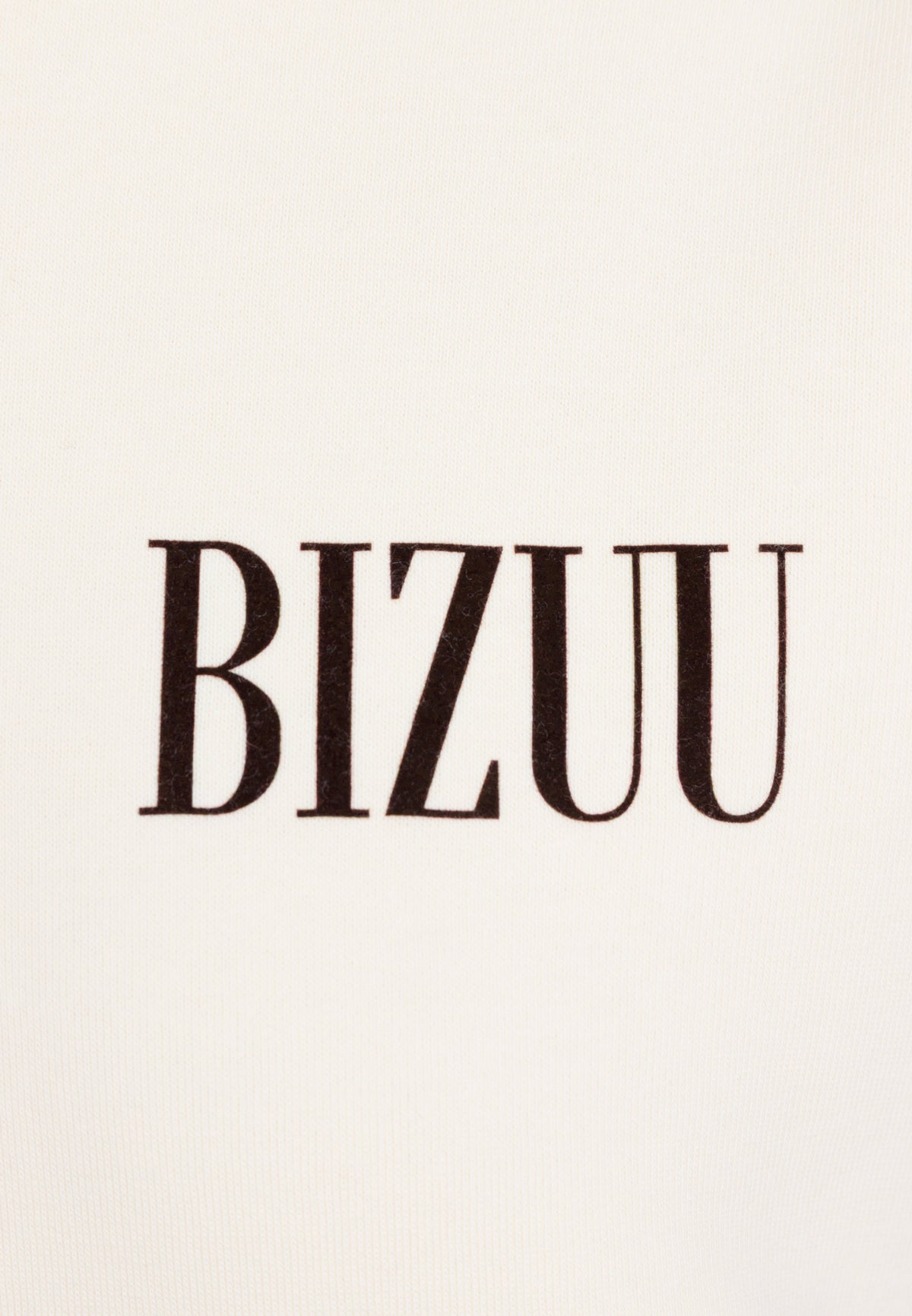 Close-up of the BIZUU logo on the front of a cream LINDI sweatshirt.