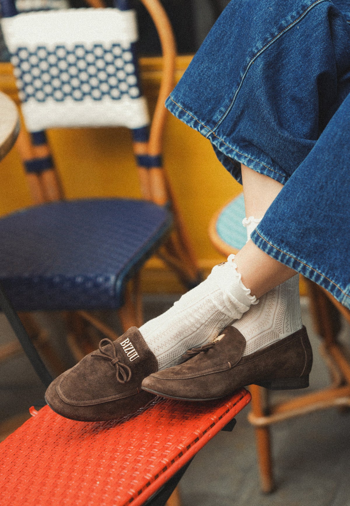 Brown LISANA suede moccasins. Decorative bow and gold Bizuu logo on the front.