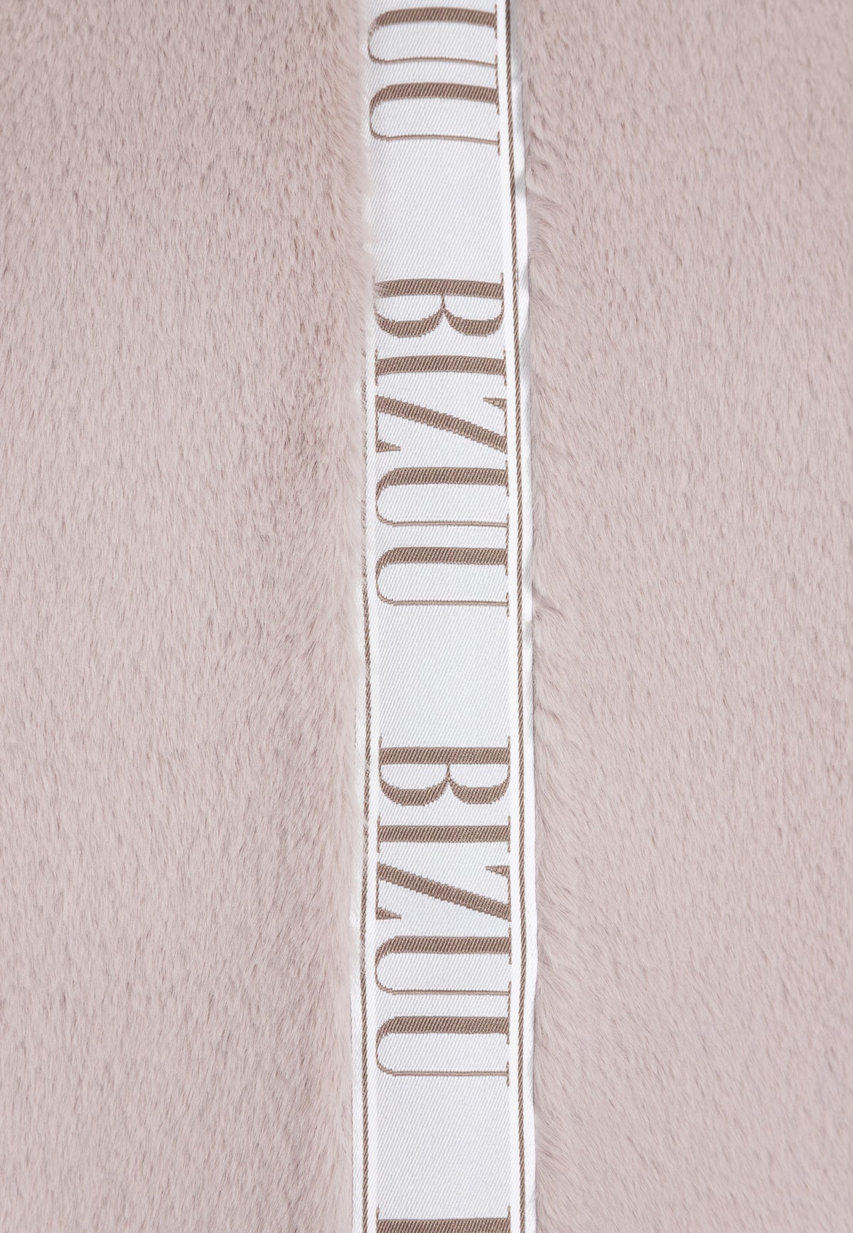 Branded tape on the back of the beige LIVORNO fur coat.
