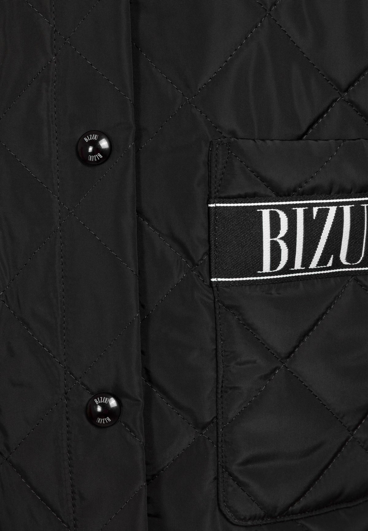 Close-up of the logo buttons and logo tape on the pocket of the MARIN jacket.