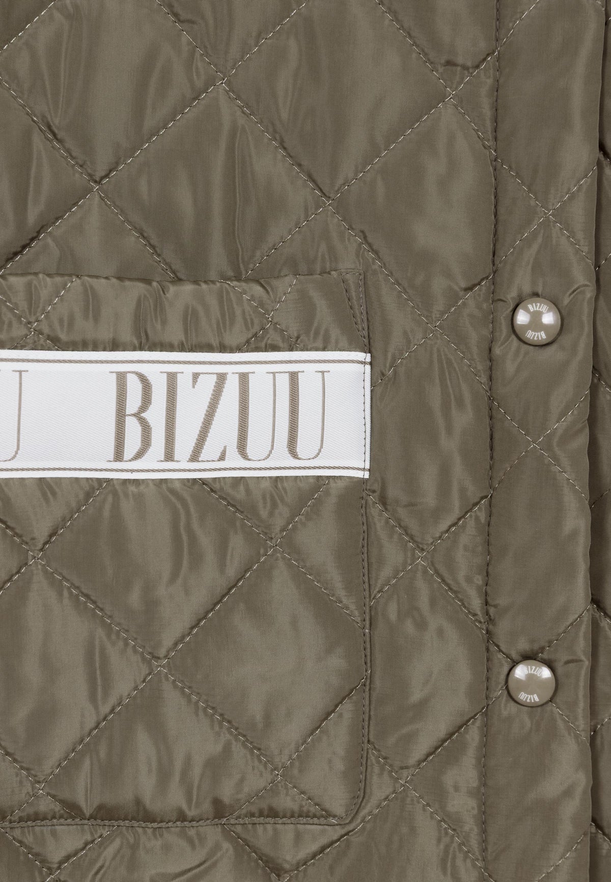Close-up of the logo buttons and logo tape on the pocket of the MARIN jacket.