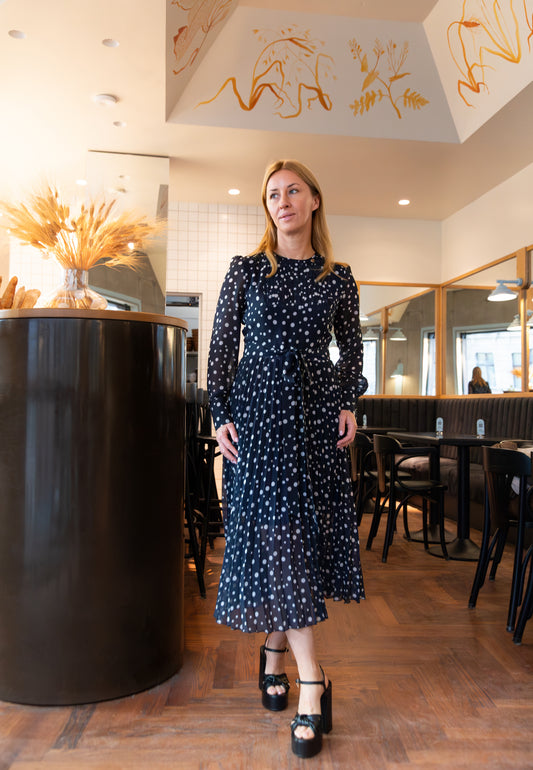 Navy polka dot dress with a pleated hem – NYLA