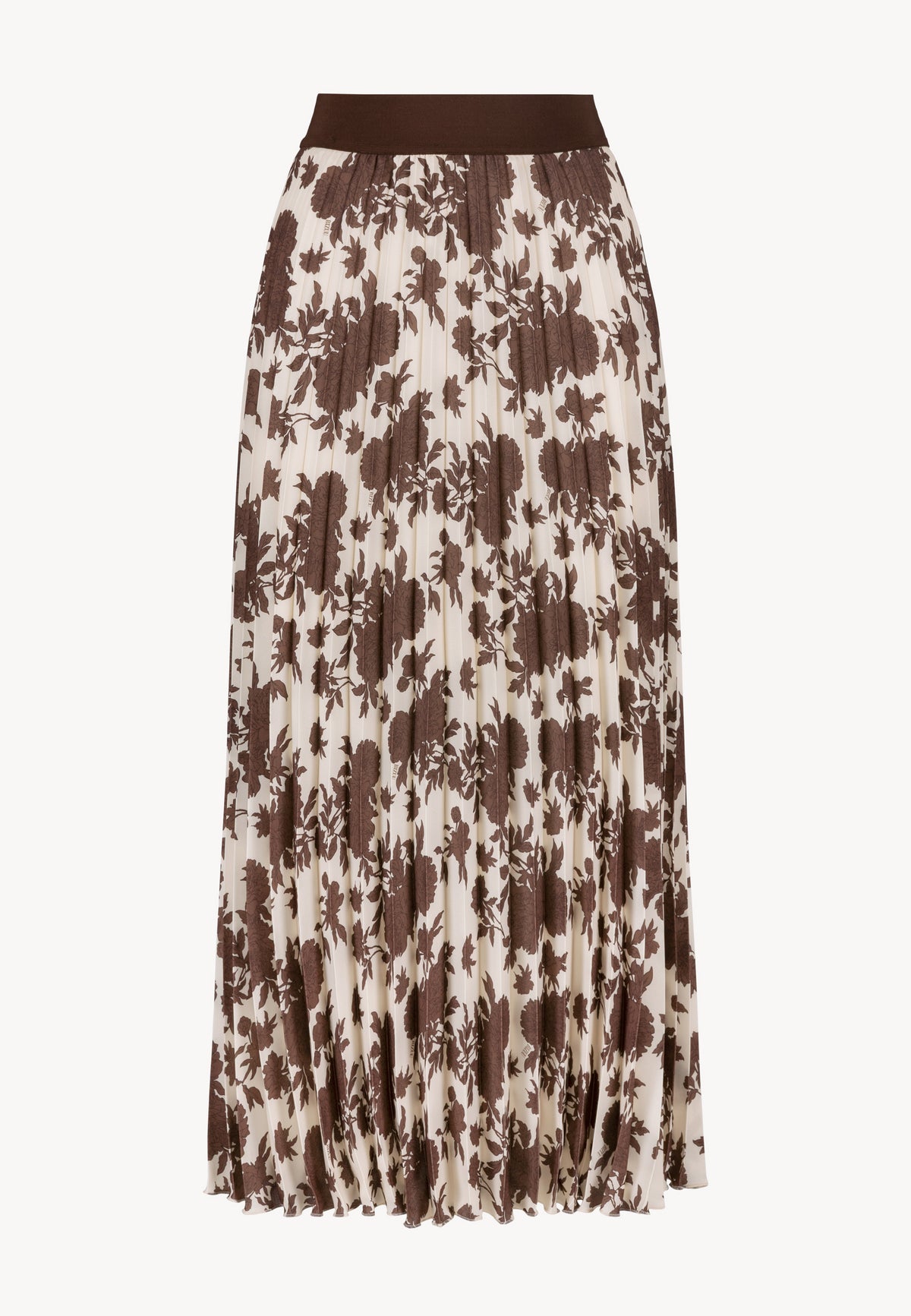 Model with hands on hips wearing the beige OWAKA turtleneck with floral print and the pleated MINA maxi skirt.