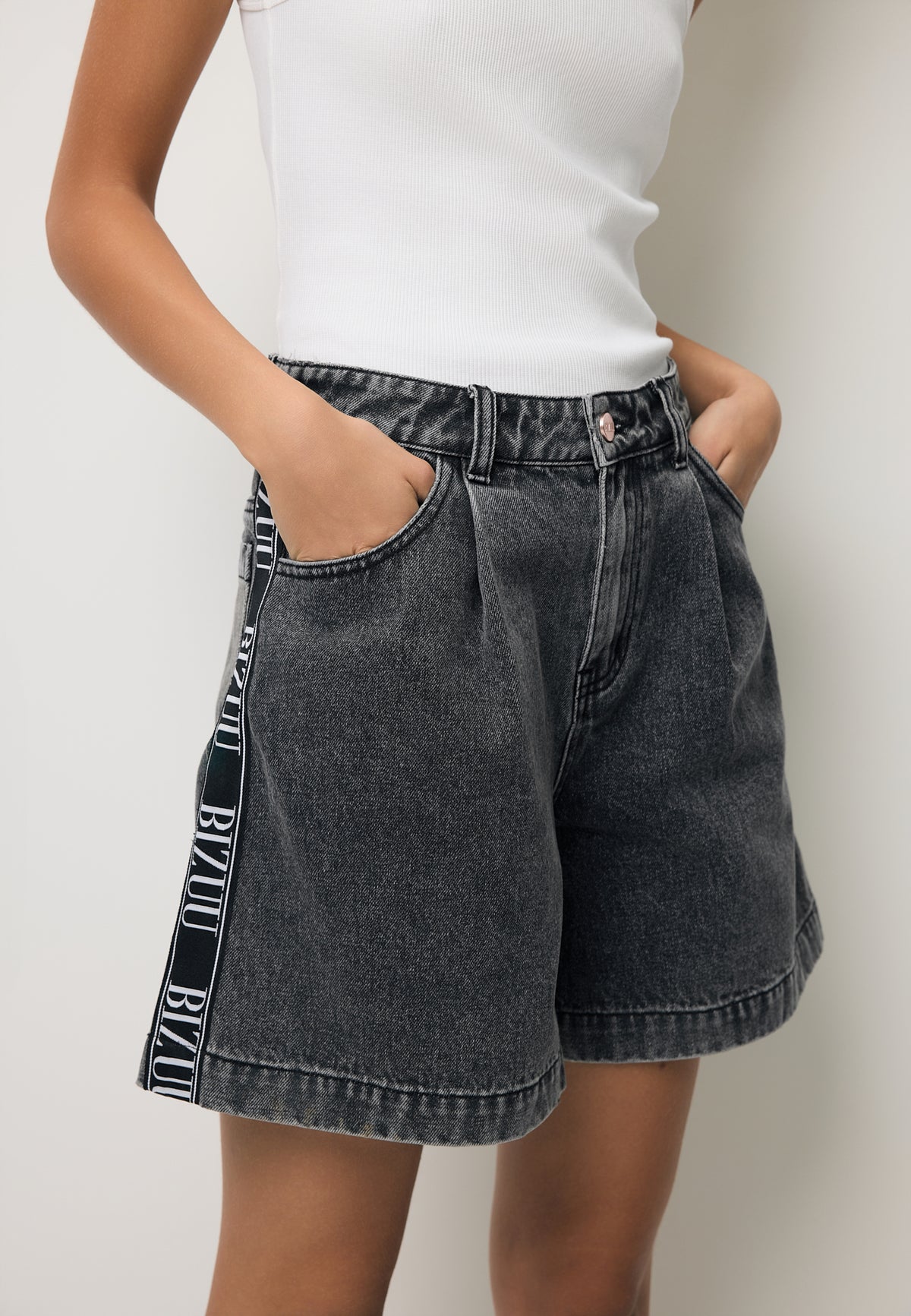 Close-up of the black MIREYA denim shorts with a logo side stripe.