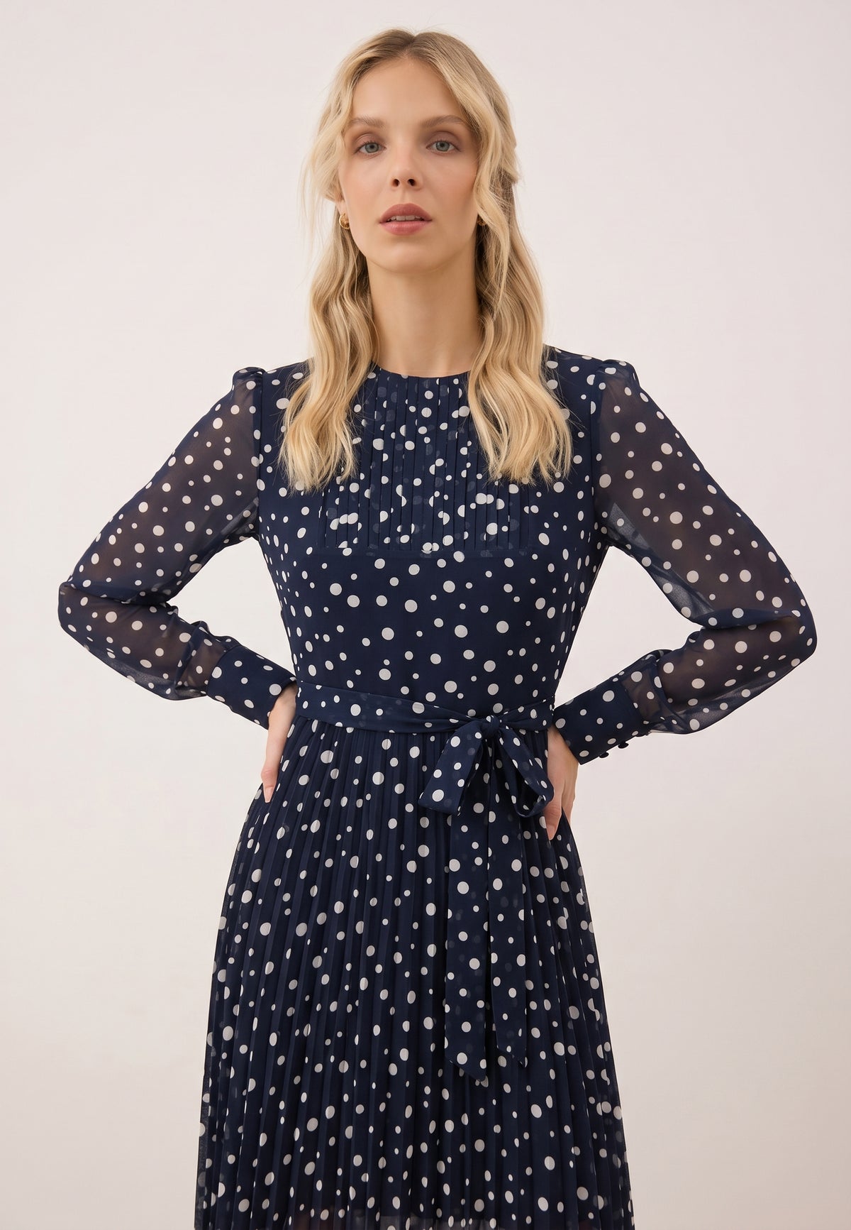 NYLA dress with a pleated hem and a waist belt.